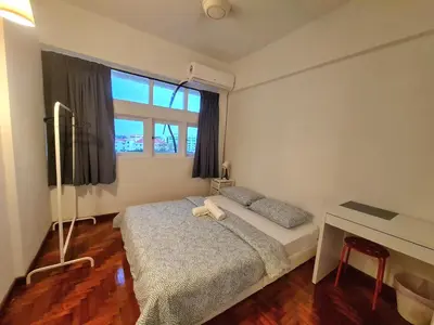 a bedroom with a bed and a desk and a window at JJ Home @ Jalan Burmah, Georgetown in George Town