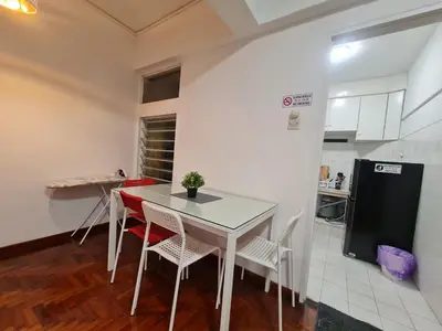 a kitchen with a table and chairs and a refrigerator at JJ Home @ Jalan Burmah, Georgetown in George Town