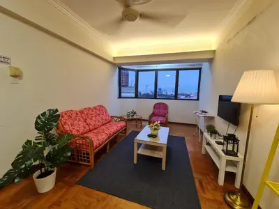 a living room with two chairs and a table at JJ Home 2 , Jalan Burmah, Georgetown in George Town
