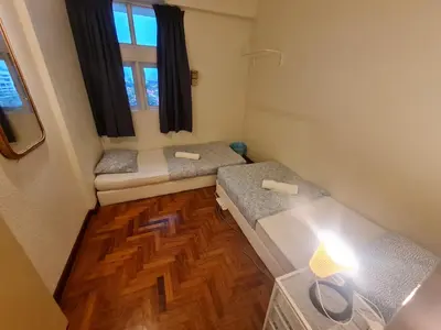 a small room with two beds and a window at JJ Home 2 , Jalan Burmah, Georgetown in George Town