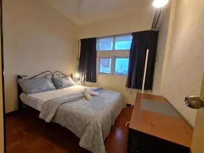 a bedroom with two beds and a window at JJ Home 2 , Jalan Burmah, Georgetown in George Town