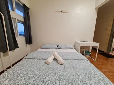 a bedroom with a bed with two pillows on it at JJ Home 2 , Jalan Burmah, Georgetown in George Town