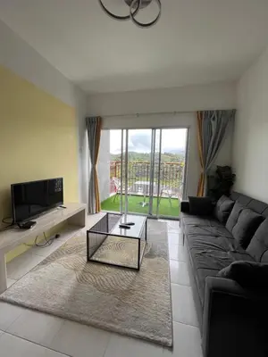 a living room with a couch and a tv at Cameron Emerald Avenue Daphne @ Brinchang in Brinchang