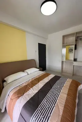 a bedroom with a large bed in a room at Cameron Emerald Avenue Daphne @ Brinchang in Brinchang
