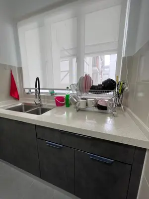a kitchen counter with a sink and a dish drying rack at Cameron Emerald Avenue Daphne @ Brinchang in Brinchang