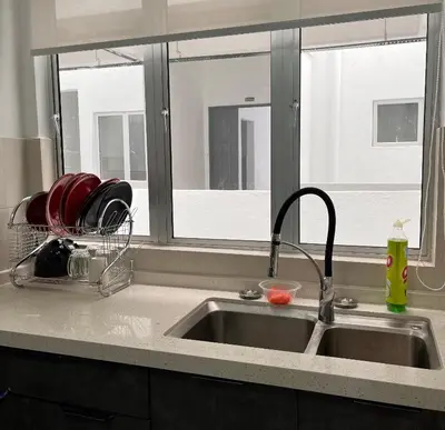 a kitchen counter with a sink and a window at Cameron Emerald Avenue Daphne @ Brinchang in Brinchang