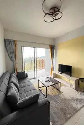 a living room with a couch and a tv at Cameron Emerald Avenue Daphne @ Brinchang in Brinchang