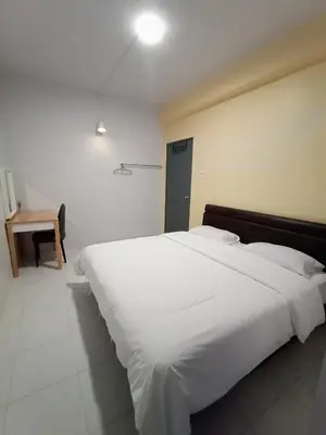 a large white bed in a room with a desk at Cameron Emerald Avenue Clover @ Brinchang in Brinchang