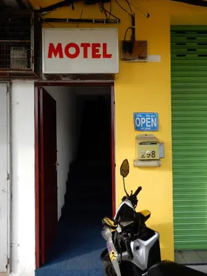 a motorcycle parked in front of a motel at LA MOTEL in Sungai Petani