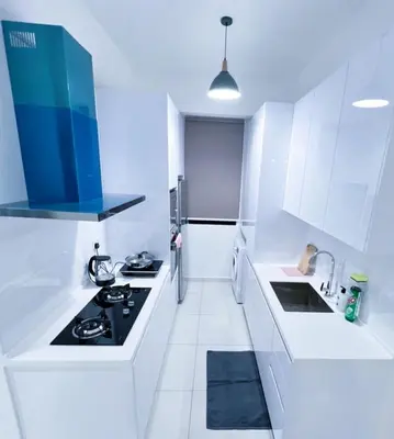 a white kitchen with a stove and a refrigerator at 2BR Georgetown Luxury Suite #RoofTopPool #Beacon in George Town