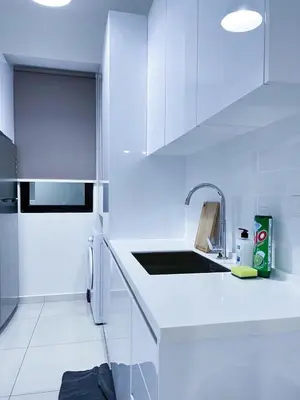 a white kitchen with white cabinets and a sink at 2BR Georgetown Luxury Suite #RoofTopPool #Beacon in George Town