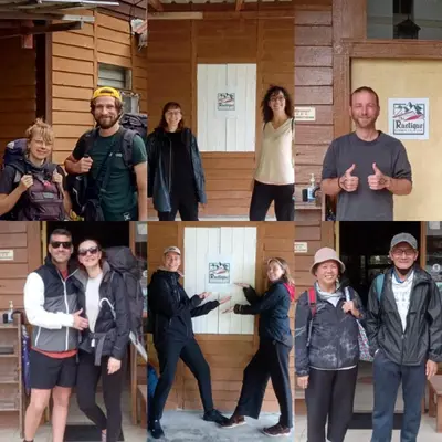 a group of people standing in front of a building at The Rustique Guest House in Tanah Rata