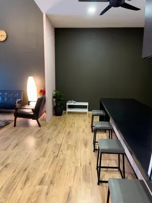 a waiting room with chairs and a table and a ceiling fan at Paradise Penthouse 5 bedrooms 5 bathrooms in Tanah Rata