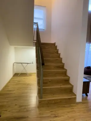a staircase in a living room with wooden floors at Paradise Penthouse 5 bedrooms 5 bathrooms in Tanah Rata