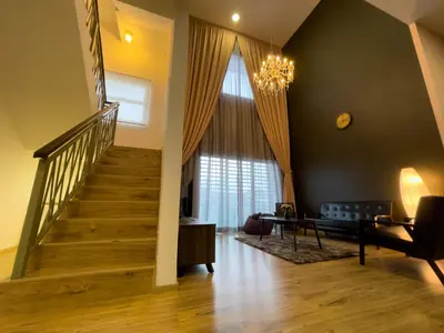 a living room with a staircase and a window at Paradise Penthouse 5 bedrooms 5 bathrooms in Tanah Rata
