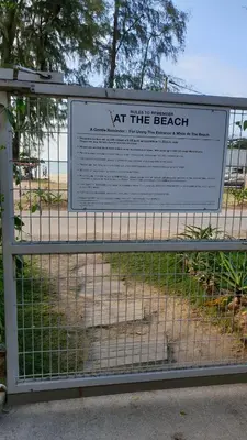 a sign on a gate at the beach at TESS - By The Sea, Batu Ferringhi Penang in Batu Ferringhi