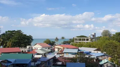 a group of houses with the ocean in the background at TESS - By The Sea, Batu Ferringhi Penang in Batu Ferringhi