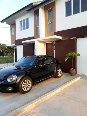 a black car parked in front of a house at Citra Cottage Homestay in Sungai Petani