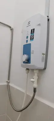 a water dispenser on the wall of a bathroom at Citra Cottage Homestay in Sungai Petani