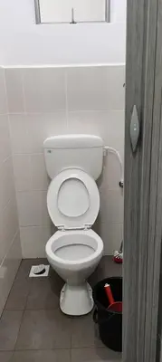 a bathroom with a white toilet in a stall at Citra Cottage Homestay in Sungai Petani