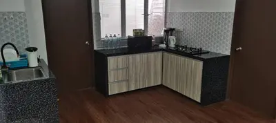 a kitchen with a counter top and a window at Citra Cottage Homestay in Sungai Petani