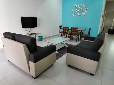 a living room with two chairs and a tv at My Homestay N43 (14 pax) @ Golden Hills Night Market in Tanah Rata