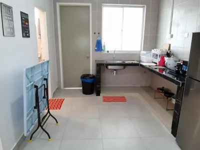 a kitchen with a white tiled floor and a sink at My Homestay N43 (14 pax) @ Golden Hills Night Market in Tanah Rata