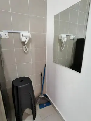 a bathroom with a mirror and a toilet brush at My Homestay N43 (14 pax) @ Golden Hills Night Market in Tanah Rata
