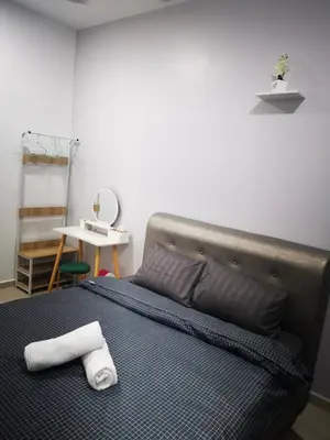 a bedroom with a bed with a towel on it at 48 \u60a0\u4e4b\u5904NO . 48, PERSIARAN ALAM IMPIAN 3 VILLA RIADAH ALAM IMPIAN PANGKOR, 32300 PANGKOR , PERAK. in Pangkor