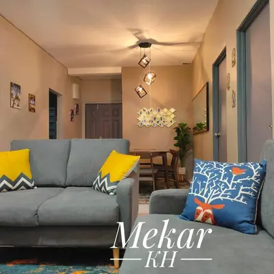 a living room with a gray couch and yellow pillows at Mekar KH Homestay (Muslim) @ Brinchang in Brinchang