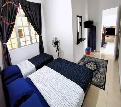 a bedroom with a blue and white bed and a window at Tiara Homestay 2 with 3 Bedroom, Unlimited Wifi - Brinchang in Brinchang
