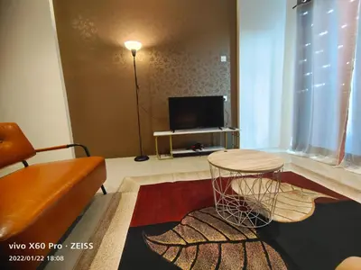 a living room with a table and a couch at PavilionVillie Ipoh in Kampong Sengat