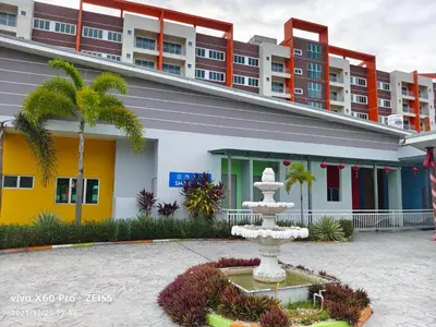 a fountain in a courtyard in front of a building at PavilionVillie Ipoh in Kampong Sengat