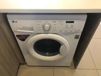 a washing machine in a bathroom under a counter at Tropicana 218 Macalister Water Purifier By Blue Sky Holidays in George Town