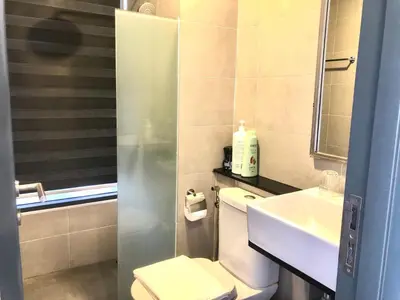 a small bathroom with a toilet and a sink at Tropicana 218 Macalister Water Purifier By Blue Sky Holidays in George Town