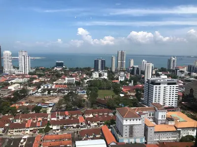 an aerial view of a city with buildings and the ocean at Tropicana 218 Macalister Water Purifier By Blue Sky Holidays in George Town