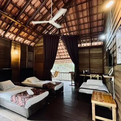 a room with three beds and a desk and a ceiling at Sahom Valley Resort - Agro & Eco Park in Kampar