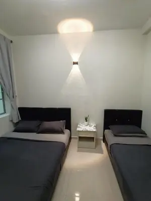 a small room with two beds and a table at Dream 2 in Cameron Highlands