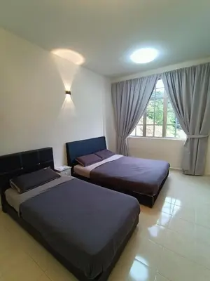 a bedroom with two beds and a window at Dream 2 in Cameron Highlands