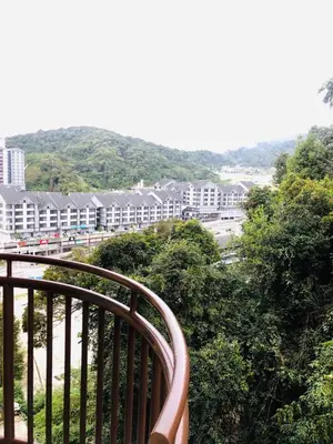 a balcony with a view of a city with buildings at BRINCHANG CENTRE 3 ROOMS APARTMENT in Cameron Highlands