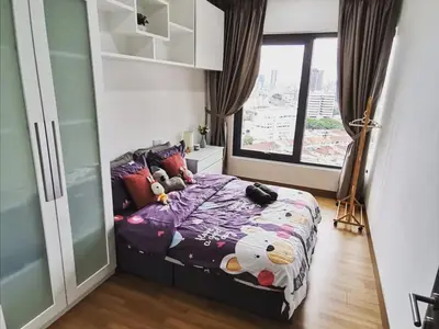 a bedroom with a bed with stuffed animals on it at Tropicana 218 Macalister at Georgetown 2Carparks in George Town