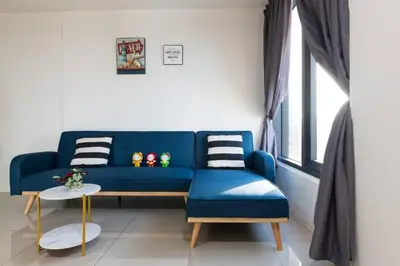 a blue couch in a living room with a window at Tropicana 218 Macalister at Georgetown 2Carparks in George Town