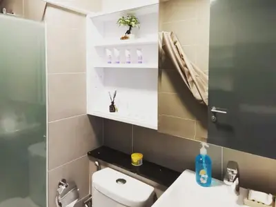 a bathroom with a toilet and a sink and a mirror at Tropicana 218 Macalister at Georgetown 2Carparks in George Town