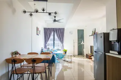 a kitchen and living room with a table and chairs at Tropicana 218 Macalister at Georgetown 2Carparks in George Town