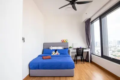 a bedroom with a blue bed with a desk and window at Tropicana 218 Macalister at Georgetown 2Carparks in George Town