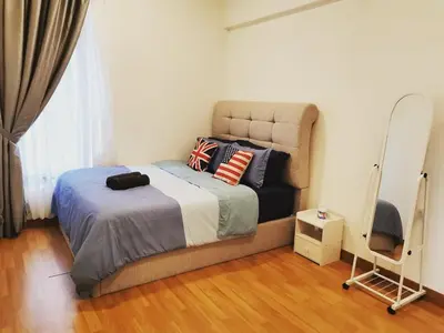 a bedroom with a bed and a chair at Tropicana 218 Macalister at Georgetown 2Carparks in George Town