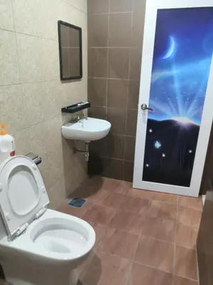 a bathroom with a toilet and a sink at Orkid Apartment in Cameron Highlands