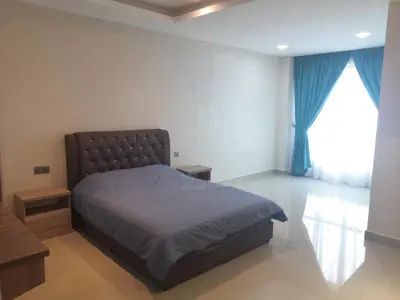 a bedroom with a bed and a large window at Orkid Apartment in Cameron Highlands