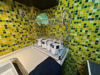 a tiled bathroom with a rack with five cups at MAGICAL HOMESTAY CAMERON HIGHLANDS in Cameron Highlands