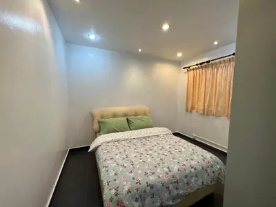 a small bedroom with a bed and a window at MAGICAL HOMESTAY CAMERON HIGHLANDS in Cameron Highlands